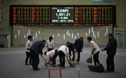 Workers sweep the floor after