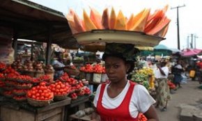 A woman carries fruit to sell in the market on World Food Day in Lagos, Nigeria. The UN's Food and Agricultural Organization is marking World Food Day to highlight the importance of global food security. The FAO said hunger is declining in Asia and Latin America but is rising in Africa. One in eight people around the world goes to bed hungry every night.